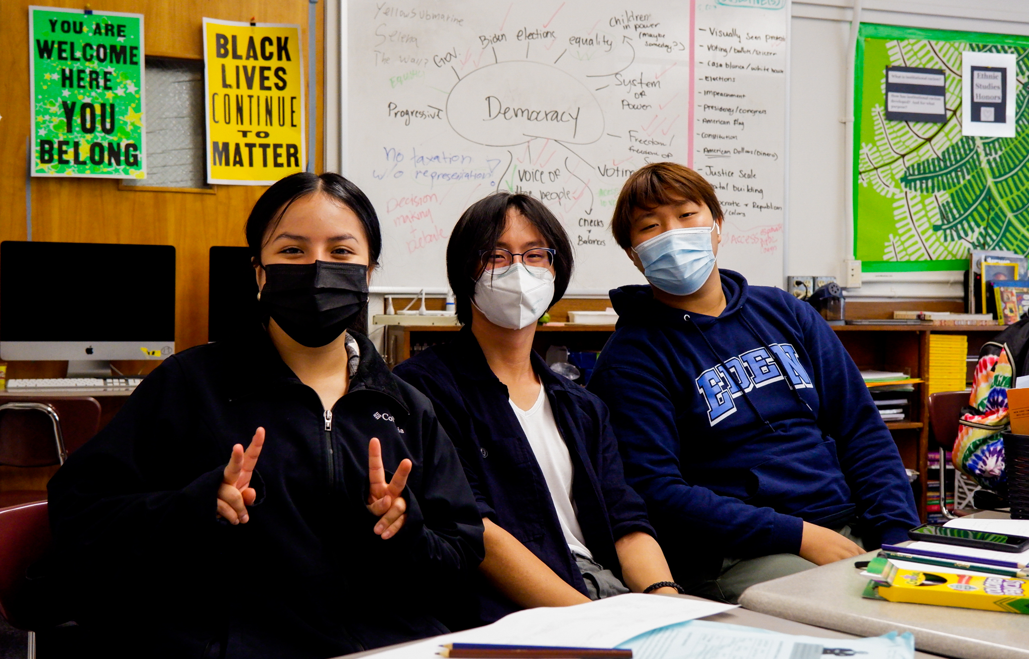 student pose making peace sign