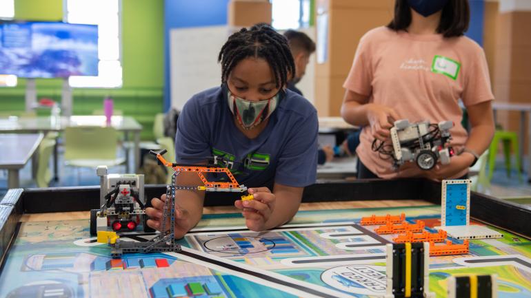 A student with a LEGO robot