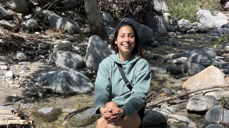 Diana posing near a creek