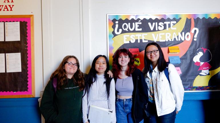 students pose in the hallway