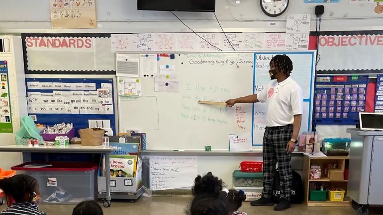 A teaching fellow leads a class