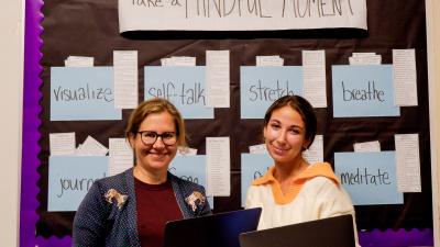 Two female teachers pose together