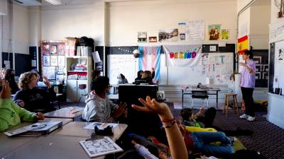 a student raises a hand in class