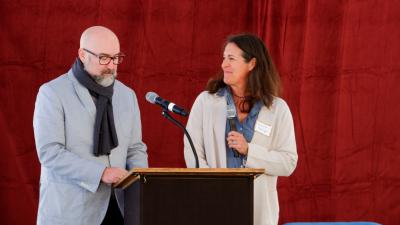 Two trustees at a podium