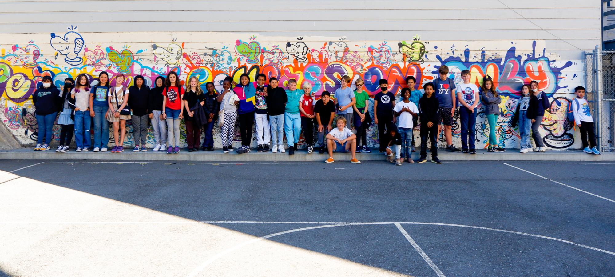 kids pose with mural