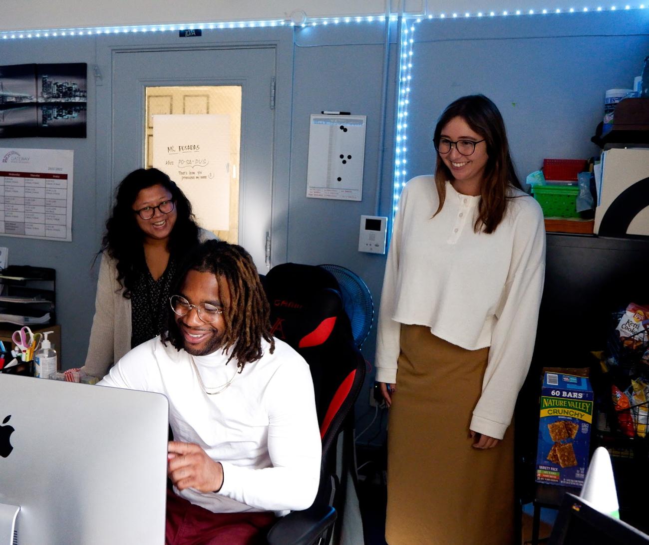 Coworkers looking at a computer