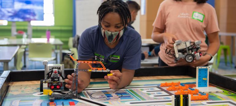 A student with a LEGO robot