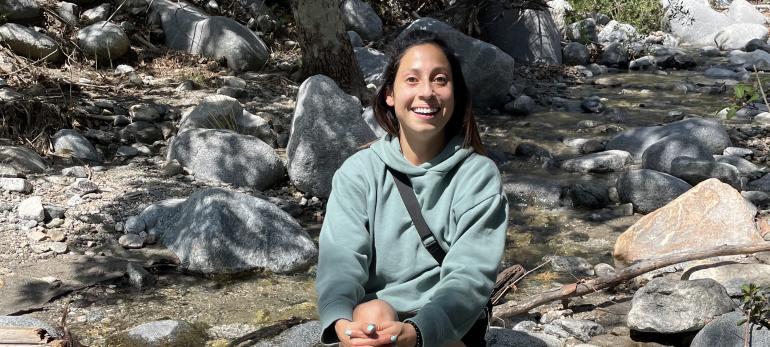 Diana posing near a creek