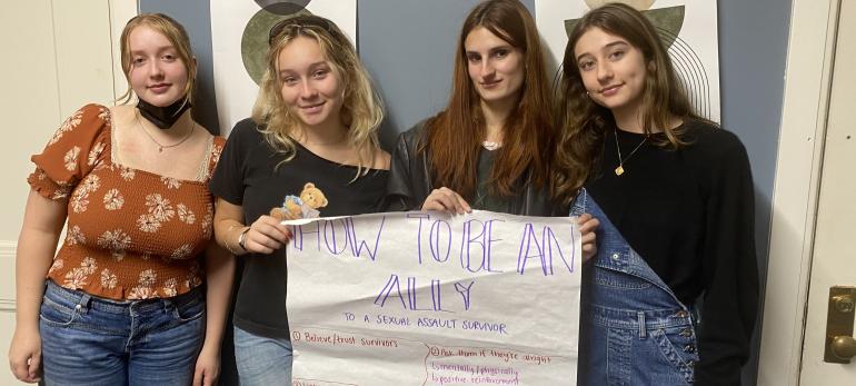 SASHA members pose with poster